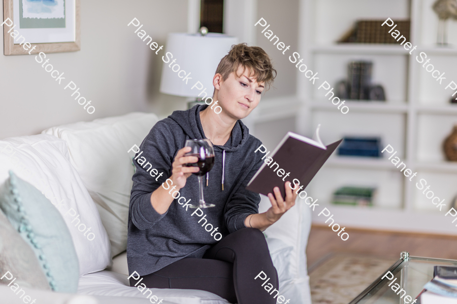 A young lady sitting on the couch stock photo with image ID: dea9b3dc-f452-499e-938c-f08bd2ab7eec