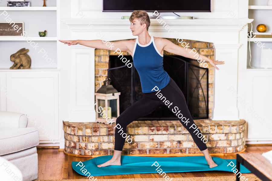 A young lady working out at home stock photo with image ID: df88f5fe-5d51-42dc-a1a5-39b86080b827