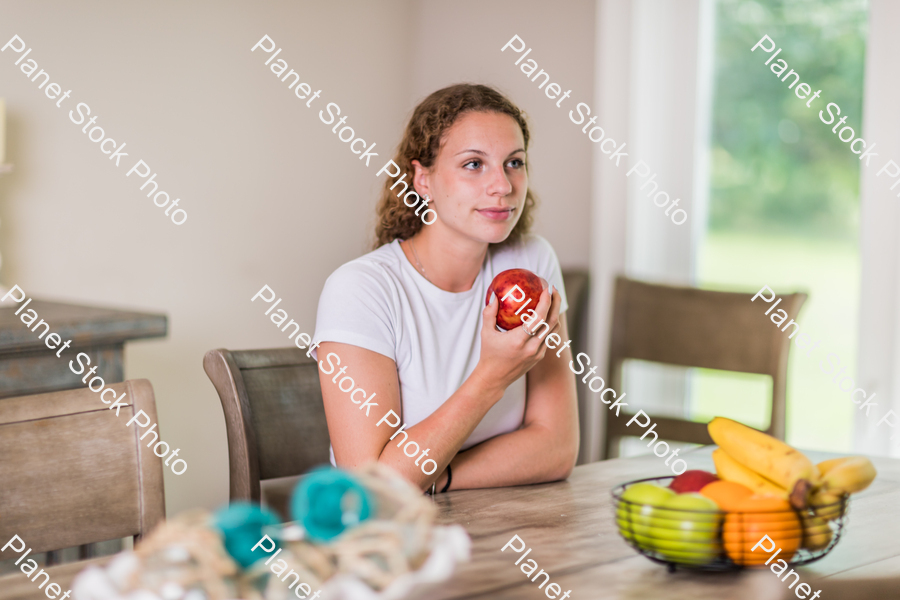 A young lady grabbing fruit stock photo with image ID: e0fdf07b-bced-4e01-abd3-691532bc548a