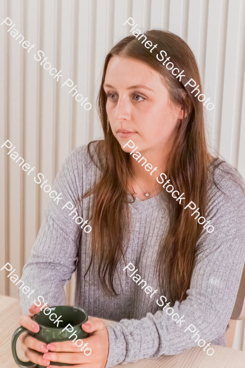 A girl sitting and enjoying a hot drink stock photo with image ID: e4f32111-d63f-4d66-9e52-50a7f925f611