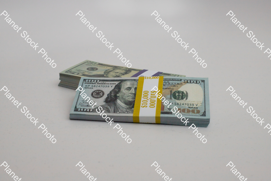 Three stacks of dollar bills stock photo with image ID: e544c6dd-9d51-41e6-9c52-604e72a9faa4