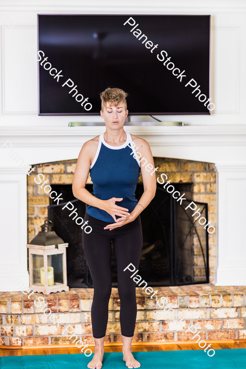 A young lady working out at home stock photo with image ID: e560282c-3401-494a-8bb8-ea82b5406726