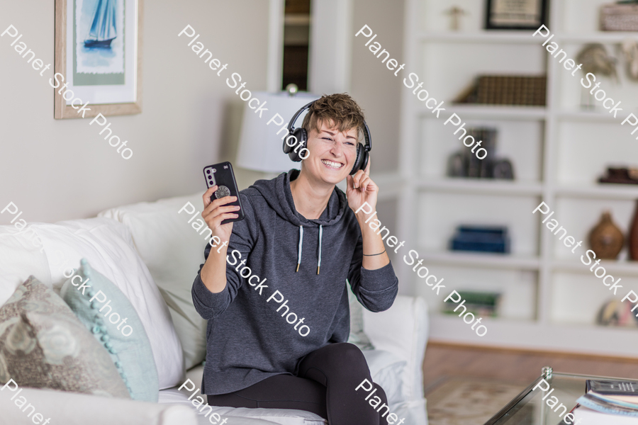 A young lady sitting on the couch stock photo with image ID: e6e4a780-a4fb-437c-9780-d76ced50a773