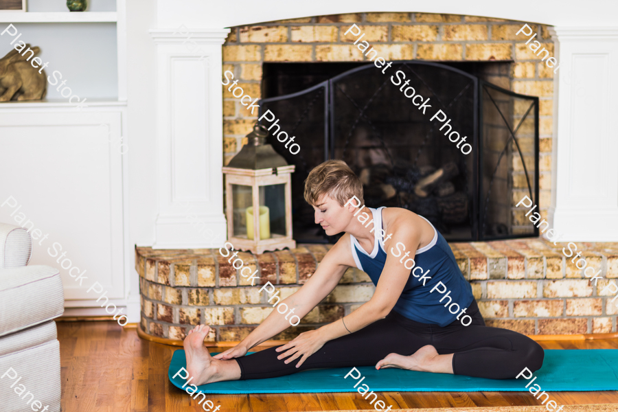 A young lady working out at home stock photo with image ID: e75ae924-7d3b-446e-aeb5-bd5ea4d9366b