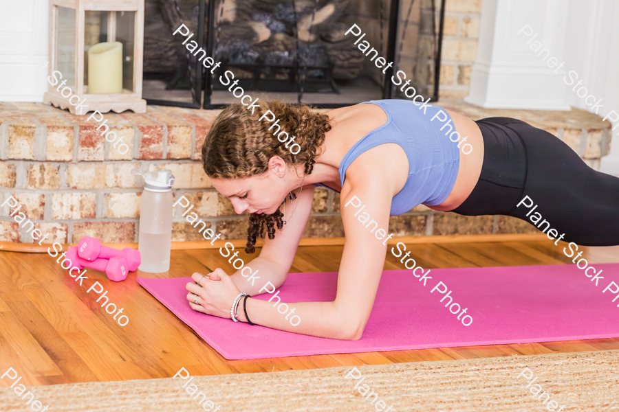 A young lady working out at home stock photo with image ID: e774942a-f675-4772-84fb-93c0bc05d21f