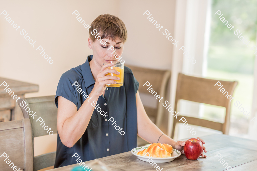 A young lady having a healthy breakfast stock photo with image ID: e779e2a4-57ef-40df-b92c-43afd4b5223f