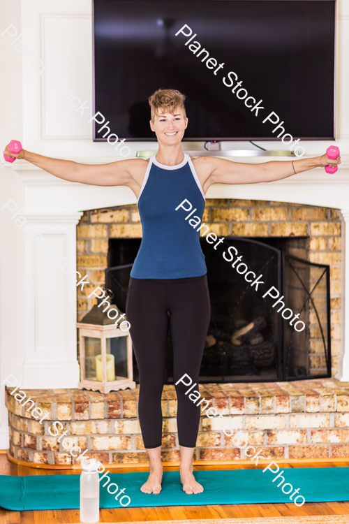 A young lady working out at home stock photo with image ID: e89d7cb6-9cdb-46a8-964f-38a88af4c93f
