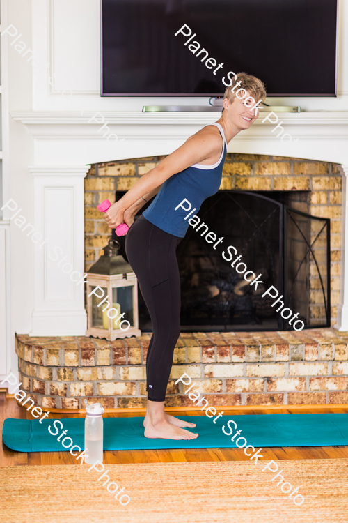 A young lady working out at home stock photo with image ID: e918d83c-ba29-4611-9852-efb854392335