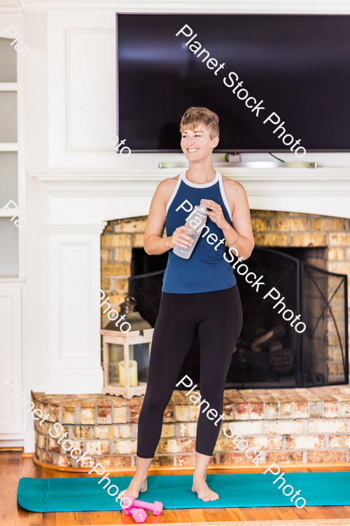 A young lady working out at home stock photo with image ID: e9bf18bf-1528-4d27-bbfc-df660a2d19e1