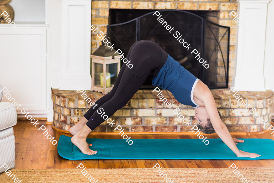 A young lady working out at home stock photo with image ID: ea1750df-aa73-48ef-b4a7-7f677cd40c8f