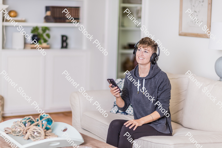 A young lady sitting on the couch stock photo with image ID: ec04bade-0f5b-4091-a09d-195b70010a82