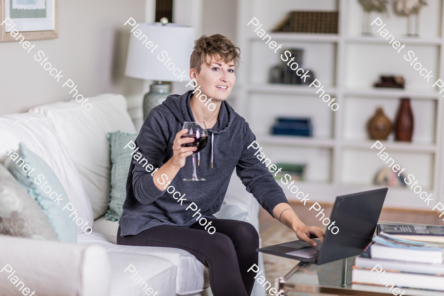 A young lady sitting on the couch stock photo with image ID: ec240ebd-231c-4fdd-a227-5fdba8b72d57