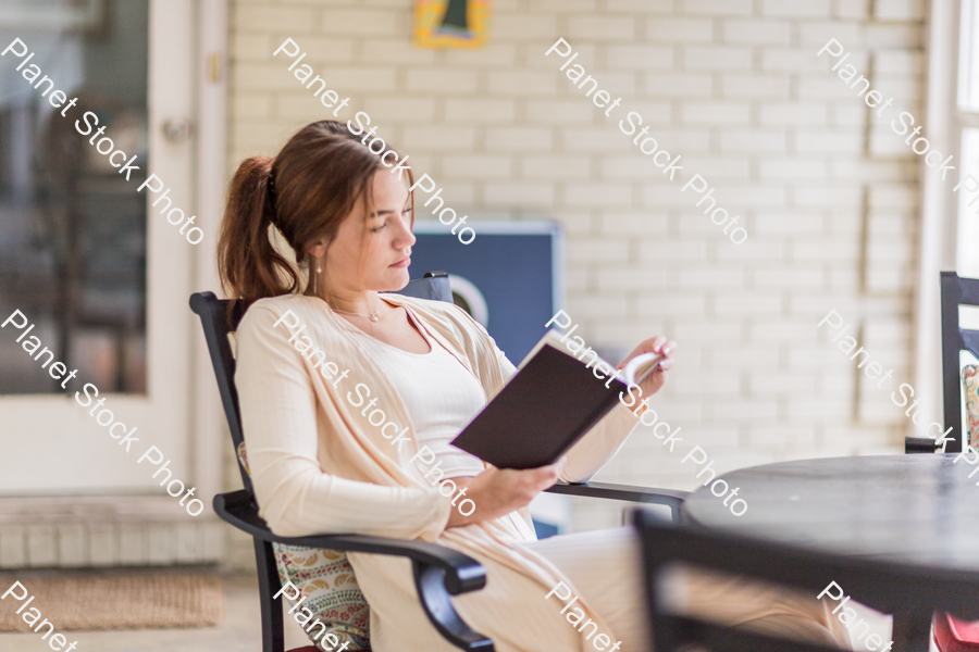 A young lady enjoying daylight at home stock photo with image ID: ed38f6b2-dc30-4669-b45d-c5e7b7da6029