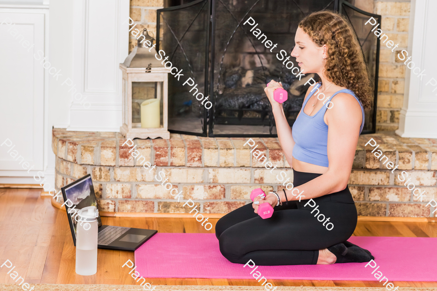 A young lady working out at home stock photo with image ID: f034ef87-78d8-4e8a-82ae-8180929d0782