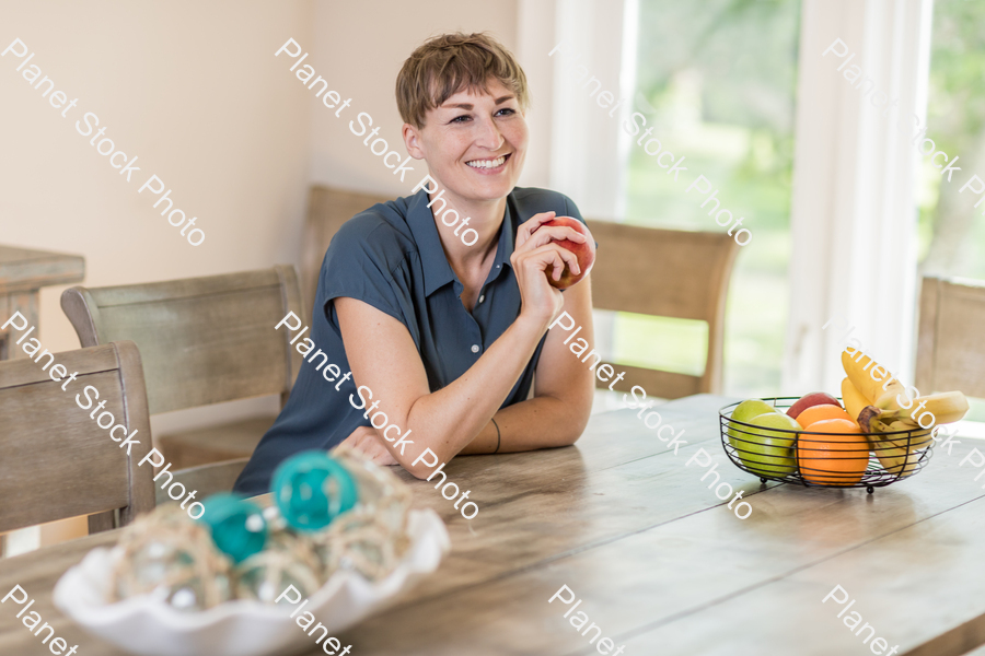 A young lady grabbing fruit stock photo with image ID: f16c4de9-58d4-46fd-a477-1b766e90f435