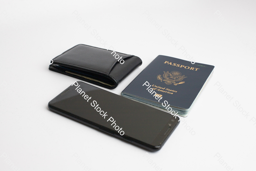 A mobile phone, with a black leather wallet, and US passport stock photo with image ID: f1811d90-90c7-4196-83c8-3e4aad6857b2