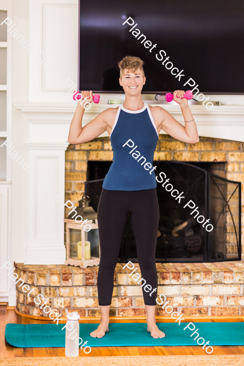 A young lady working out at home stock photo with image ID: f1882fb6-d763-4d28-88a0-04a7faaeffa6