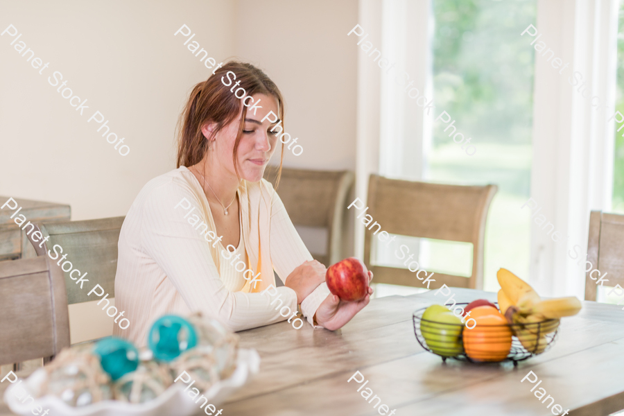 A young lady grabbing fruit stock photo with image ID: f1d8815c-ad4c-4d31-8617-771dee8a2077