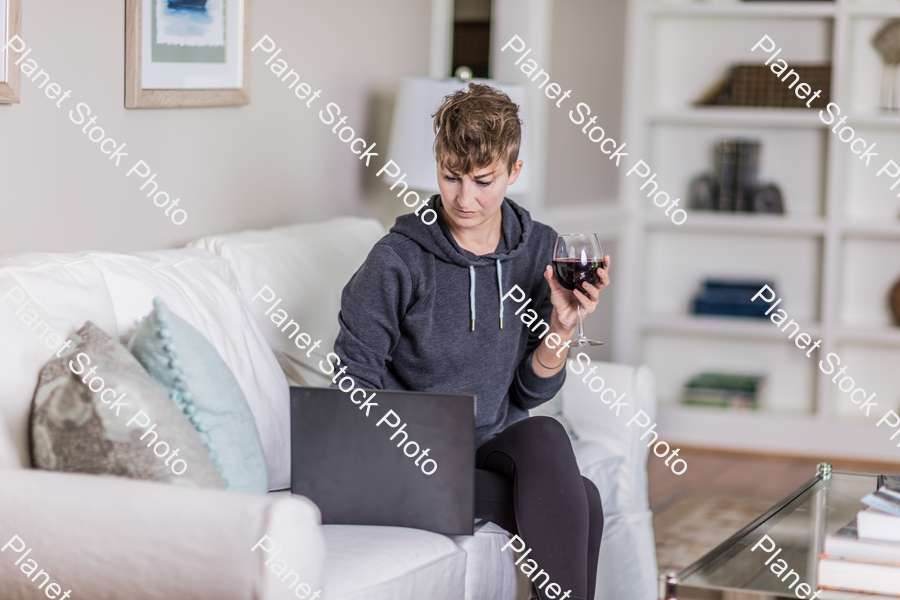 A young lady sitting on the couch stock photo with image ID: f22eff5e-b725-4645-b8fe-37a58cd78f40