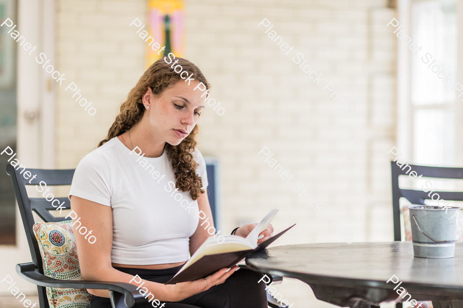 A young lady enjoying daylight at home stock photo with image ID: f62106b3-9a15-4cd8-bb0a-87e016d845c7