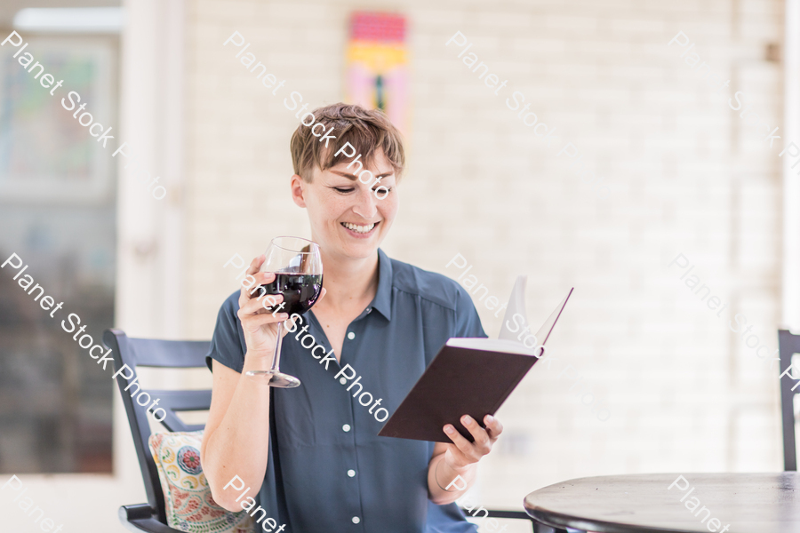 A young lady enjoying daylight at home stock photo with image ID: f6b223d0-e571-4360-90c9-3a270c1d764e