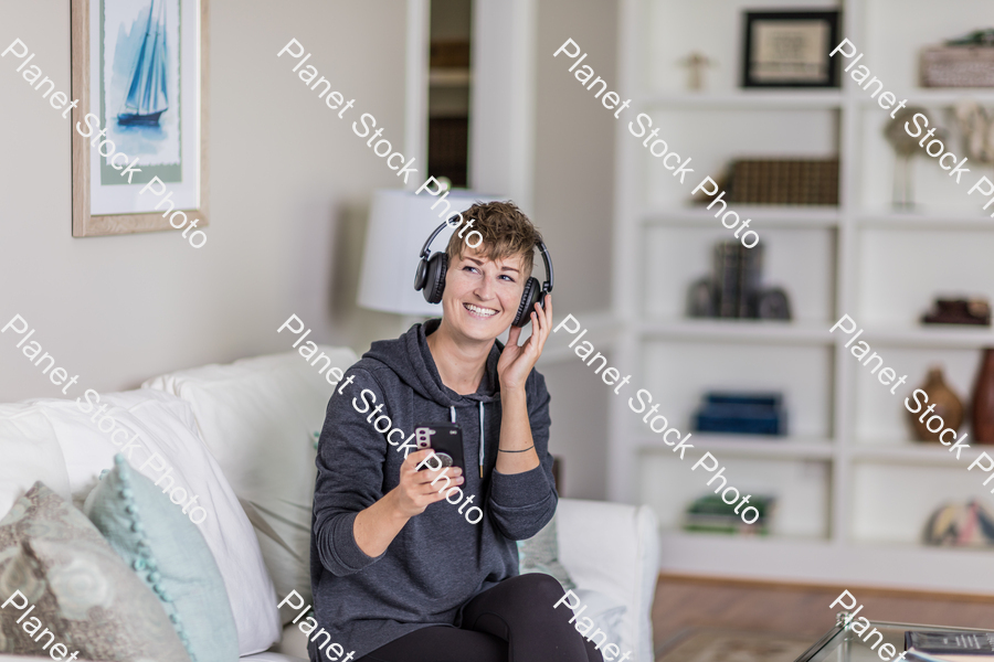 A young lady sitting on the couch stock photo with image ID: f6e75265-8e62-4e59-b1e5-2cb9ecc900c0