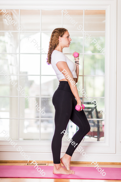 A young lady working out at home stock photo with image ID: f7b37601-6191-4c3e-aba1-3c1716ec4fba