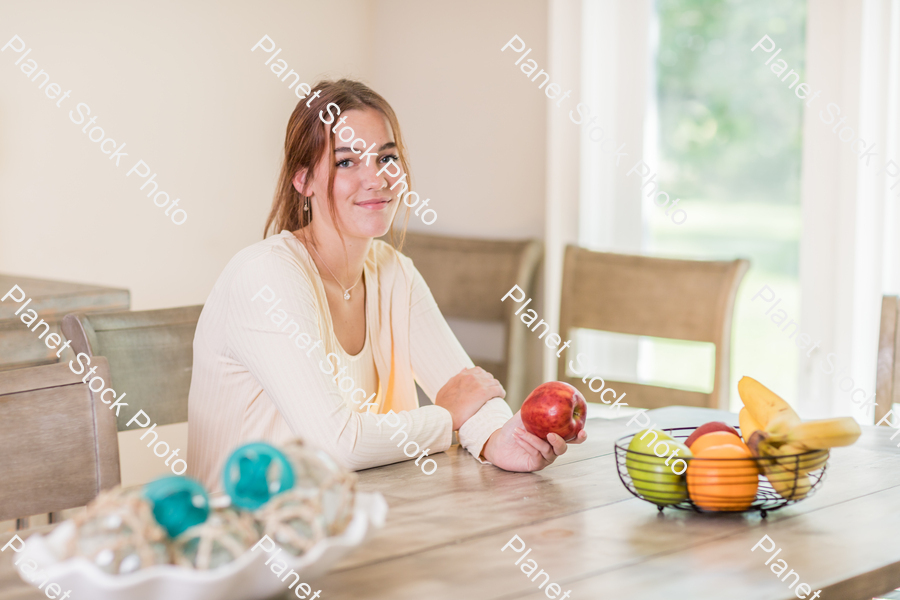 A young lady grabbing fruit stock photo with image ID: f7b9e204-1285-435a-96c1-981545cecb83