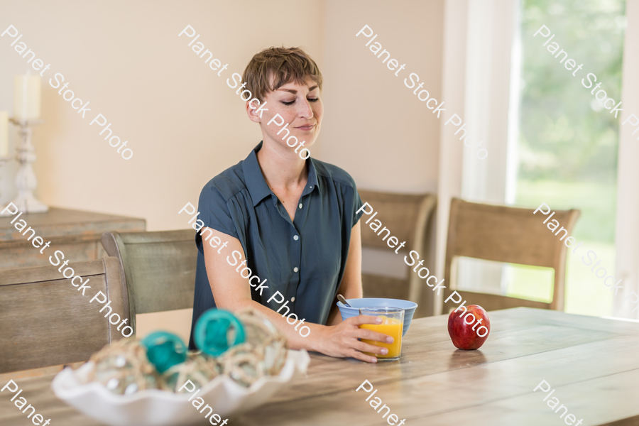 A young lady having a healthy breakfast stock photo with image ID: f7f4623b-83e5-46de-9972-acef69bfb6f8