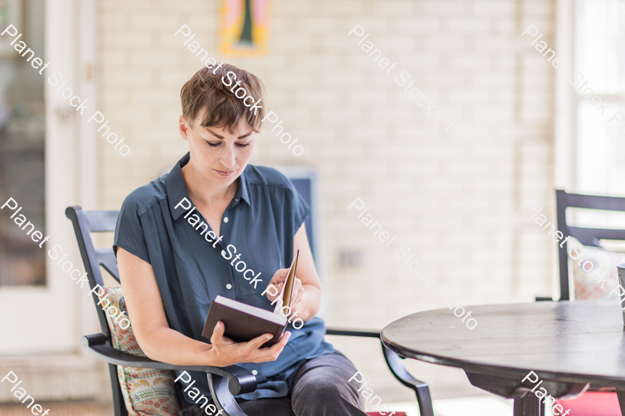 A young lady enjoying daylight at home stock photo with image ID: fa193365-0da7-4cab-b1f6-b11d82db801d