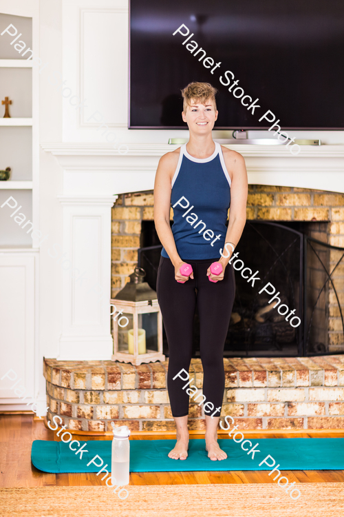 A young lady working out at home stock photo with image ID: fb638f8f-9e35-4a6c-a899-14160a5fd746