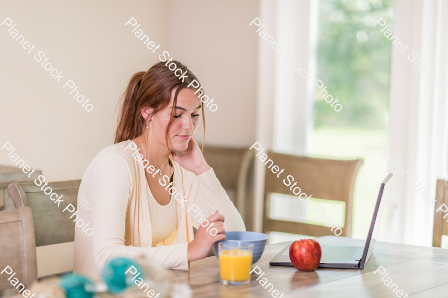 A young lady having a healthy breakfast stock photo with image ID: fc477e7c-fdd1-4ce0-87a7-c1dd2e411439