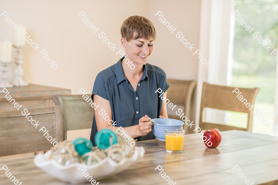 A young lady having a healthy breakfast stock photo with image ID: fc9748eb-dfc4-4f3d-af96-c81a4897111e