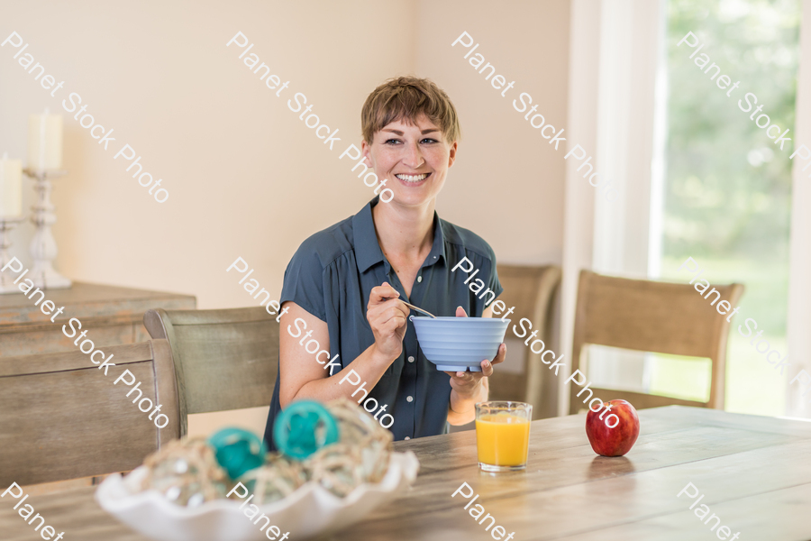 A young lady having a healthy breakfast stock photo with image ID: fde188b2-4f66-4203-979d-5e7dc3428e47
