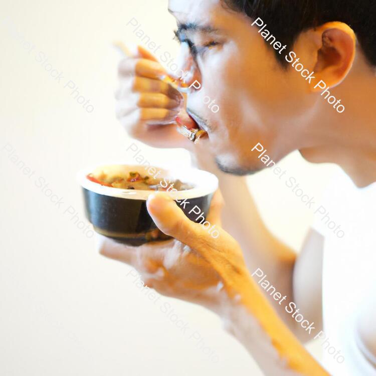 A Man Eating Food stock photo with image ID: ff23eb91-f3c4-4f6b-912a-1257bec9a9b1