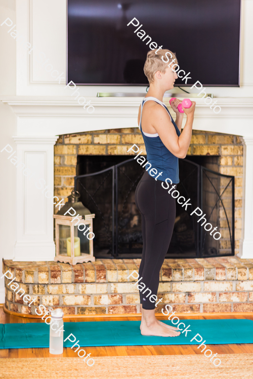 A young lady working out at home stock photo with image ID: ff2c55fd-1970-4e2d-9b3a-cb5263748d7c