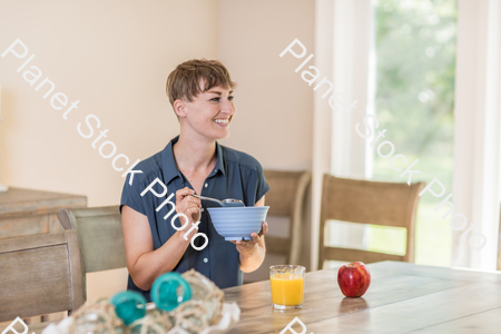 A young lady having a healthy breakfast stock photo with image ID: 07d4102a-edee-42f8-8a91-410ee741cf09
