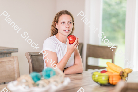 A young lady grabbing fruit stock photo with image ID: 0d2fb469-2c7a-4a2b-a6a1-b3179109c248