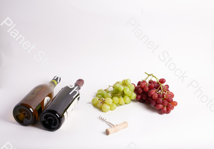 Two bottles of wine, with corkscrew, and grapes stock photo with image ID: 0e7a813f-f6f7-4a9c-b885-9ee520bc1a52