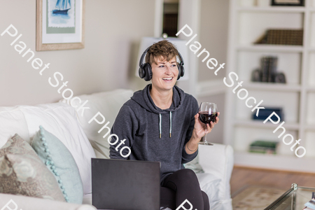 A young lady sitting on the couch stock photo with image ID: 179dc85e-2bc7-4f30-8f02-ca426e82a2ac