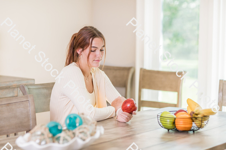 A young lady grabbing fruit stock photo with image ID: 17b80ba4-859b-4e75-9b43-a7c3b0591a82