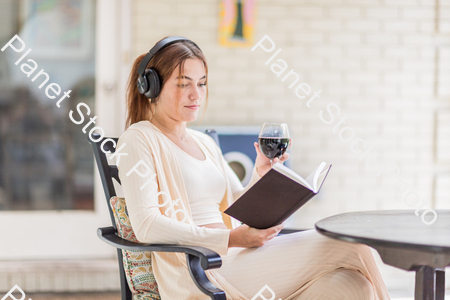 A young lady enjoying daylight at home stock photo with image ID: 180fa068-e778-4da3-af95-9ce11acc0d60