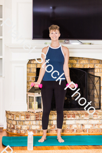 A young lady working out at home stock photo with image ID: 1a09da6e-1428-4b66-80d4-8ca742884998