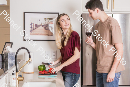 A young couple preparing a meal in the  kitchen stock photo with image ID: 22a263d6-dac7-4897-879b-064492e5167f