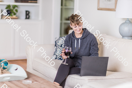 A young lady sitting on the couch stock photo with image ID: 2693e6ea-3c00-40ac-a3f5-2d5954b017a6