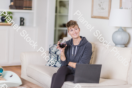 A young lady sitting on the couch stock photo with image ID: 26ed89ed-86f4-4380-9b7b-ec1aa56f6796