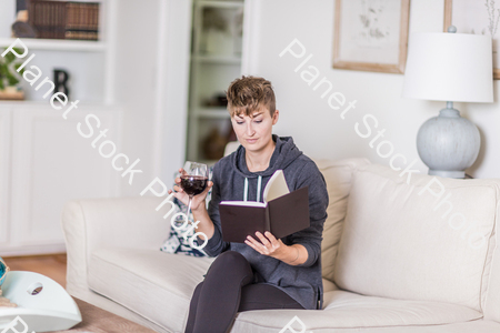 A young lady sitting on the couch stock photo with image ID: 2af83073-6a25-43ad-9306-2c5856bc41b5