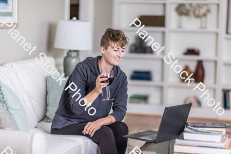 A young lady sitting on the couch stock photo with image ID: 2dfd4f6d-21a4-4c7c-8fa1-fc551d6a0dec