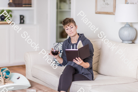 A young lady sitting on the couch stock photo with image ID: 318b427a-a6d2-424b-8beb-eb01043aaa46