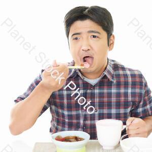 A Man Eating Food stock photo with image ID: 3259e3c3-fbcb-451e-9cd5-348b30f37d1e